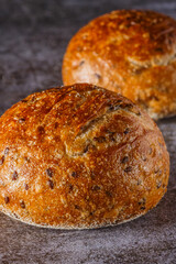 Assortment of baked bread on wooden table background Fresh fragrant bread on the table. Food concept.