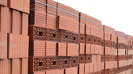 Wall blocks made from red porous ceramics with rectangular holes on a pallet 