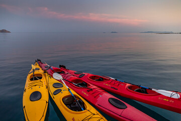 Komodo,Indonesia:November 12,2019: colorful Kayaks bound together on the ocean  at sunset
