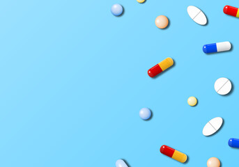 Medicines on light blue background with copy space. Realistic pills and capsules.