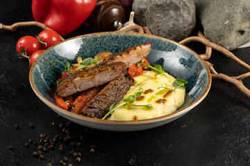 Duck steak with mashed potatoes and vegetables. A hot main course made from poultry, potatoes and stewed vegetables.