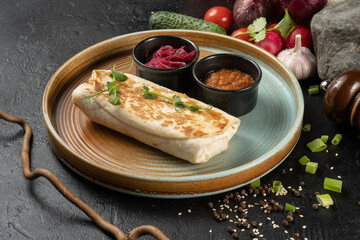 Burrito with vegetables. Shawarma. A hot appetizer of chicken and vegetables wrapped in pita bread or flatbread.