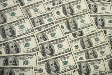 A money pile of one hundred US banknotes with president Franklin portrait. Cash of hundred dollar bills, paper currency background