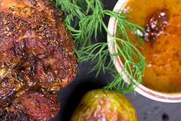roast with herbs on a black stone © Patrycja