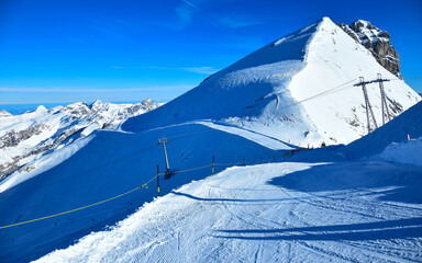 Snowed ski slopes in swiss Alps. Top of the glacier panorama. Switzerland.