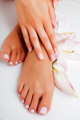 Fototapeta premium manicure pedicure with flower lily closeup isolated on white perfect shape hands spa salon