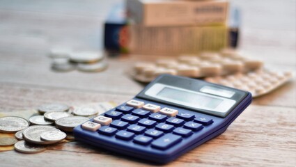 calculator, money and tablets on a wooden table
