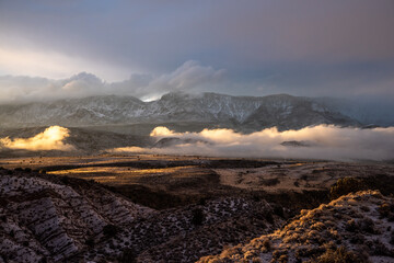 Winter storm clouds settle in a desert valley at sunset, Southern Utah