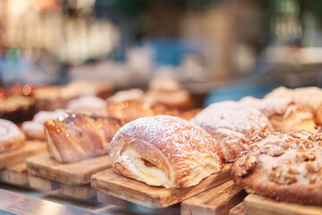 Sweets and croissants displayed in a pastry shop window