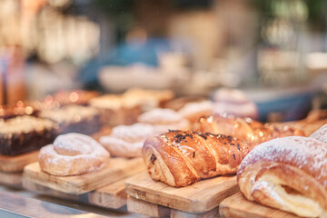 Sweets and croissants displayed in a pastry shop window