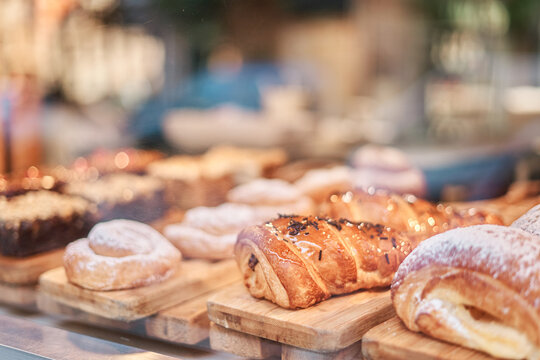 Sweets and croissants displayed in a pastry shop window