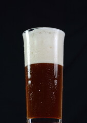Irish red ale isolated on a black background.
