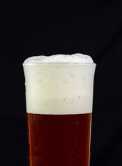 Irish red ale isolated on a black background.