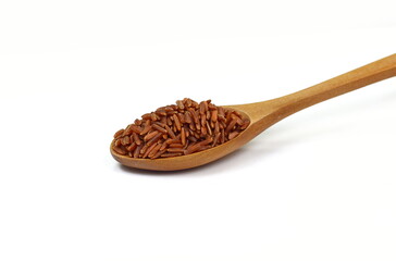 Red wild rice in a wooden spoon isolated on white background