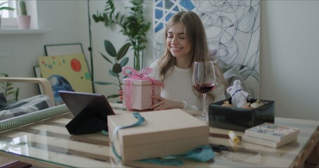 Woman wrapping Christmas presents gift