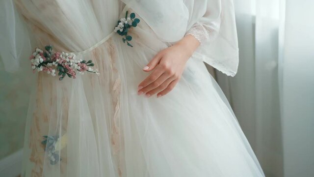 Close up of beautiful wedding dress in arm