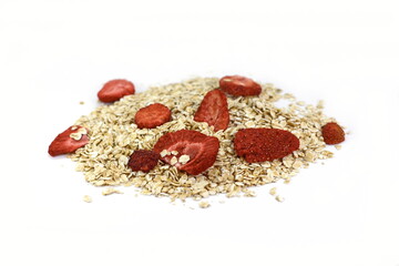 Healthy food. Rye oat flakes with dried strawberries isolated on white background.