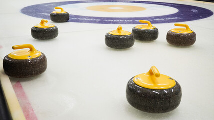 Granite stones for curling on white ice close-up.Winter sport, team game.Curling Club.