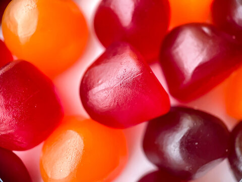 Close-up Texture Of Red, Orange And Purple Multivitamin Gummies. Healthy Lifestyle Concept.