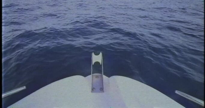 Boat sailing over sea made with vintage VHS effect . Grain and noise VHS footage. Boat travel and sea