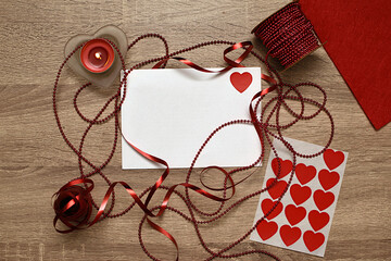 White letter, candle, ribbon and heart shaped candies. Gift for lovers