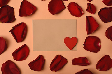 An envelope surrounded by rose petals and a heart. Symbol of love and romance
