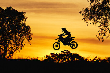 Fototapeta na wymiar Silhouette scene of the jumping motocross