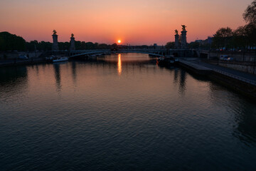 sun rising over the river seine and Pont Alexandre III bridge in Paris