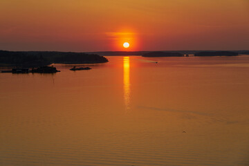 Fototapeta na wymiar Golden sunset in Naantali, Finland. Reflecton of the sun on the water.