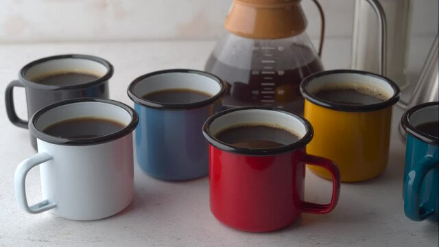 coffee in many colorful mugs on white background