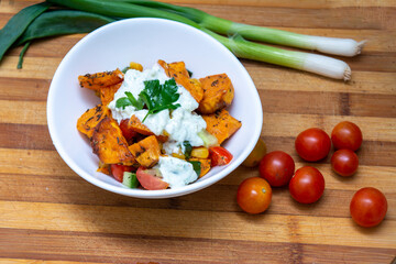 Sweet potatoes with a mexican flavor of cherry tomatoes, corn, onion and cucumber