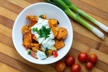 Sweet potatoes with a mexican flavor of cherry tomatoes, corn, onion and cucumber