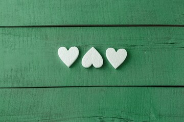 wood blue background texture with white foam hearts