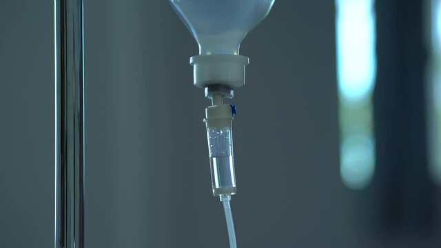 Closeup of IV drip in hospital, Intravenous saline solution, IV fluid loading dose. 0.9% NSS drip.