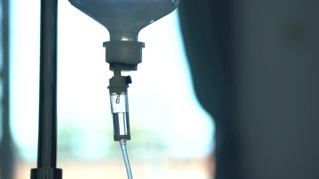 Closeup of IV drip in hospital, Intravenous saline solution, IV fluid loading dose. 0.9% NSS drip.