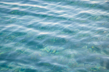 Ripples on clear tropical blue water in the sea.