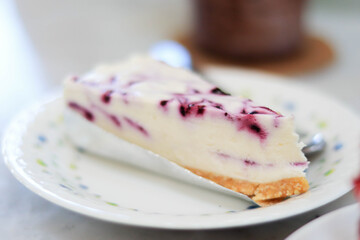 Blueberry Cheesecake is placed on a white plate in the cafe.