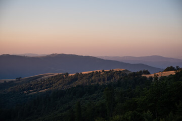 Beautiful mountain landscape of green and yellow meadows on Balkan Mountains in Serbia.Sunlit highlands and grasslands of Old mountain with distant peaks.Hiking trail for the highest peak Midzor 2169m
