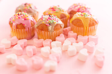small colorful cakes with pink and white heart shaped marshmallows