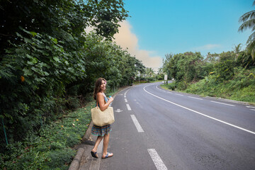 Obraz premium Woman walking on main road in tropical island Moorea in French Polynesia