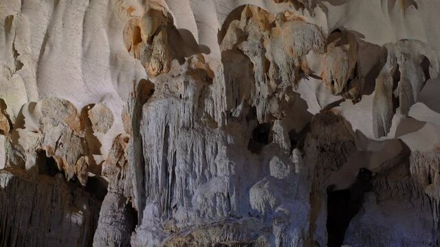 Stalactites inside of the biggest cave in the Halong Bay national park in Vietnam consisting of thousands of small and big limestone islands. Travel to Vietnam concept