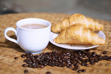 cup of coffee with croissant