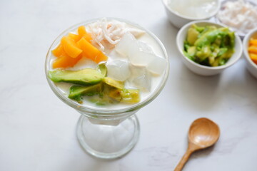 a bowl of fruit cream soup and the ingredients in white background