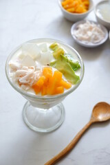 bowl of fruit soup and the ingredients in white background 