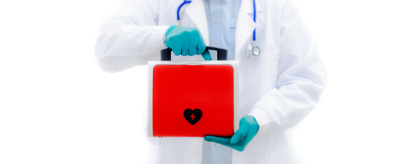 Aed rescue equipment Or a red heart defibrillator In the doctor's hand White background