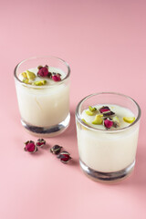 Mahalabia or malabi. Arabic milk pudding topping wit rose and pistachio.
