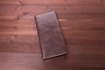 Brown purse on wood background