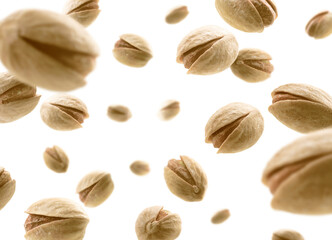 Salted pistachios levitate on a white background