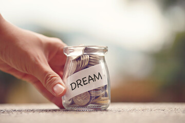 Money jar with Dream text. Savings and investment concept.