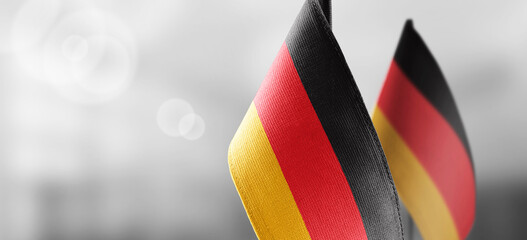 Small national flags of the Germany on a light blurry background